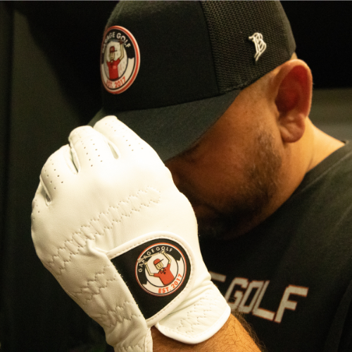 man wearing The Triple G golf glove and holding hat
