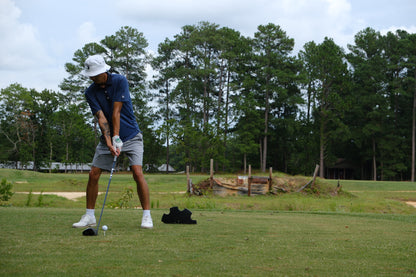 man playing golf wearing The Shrink golf glove