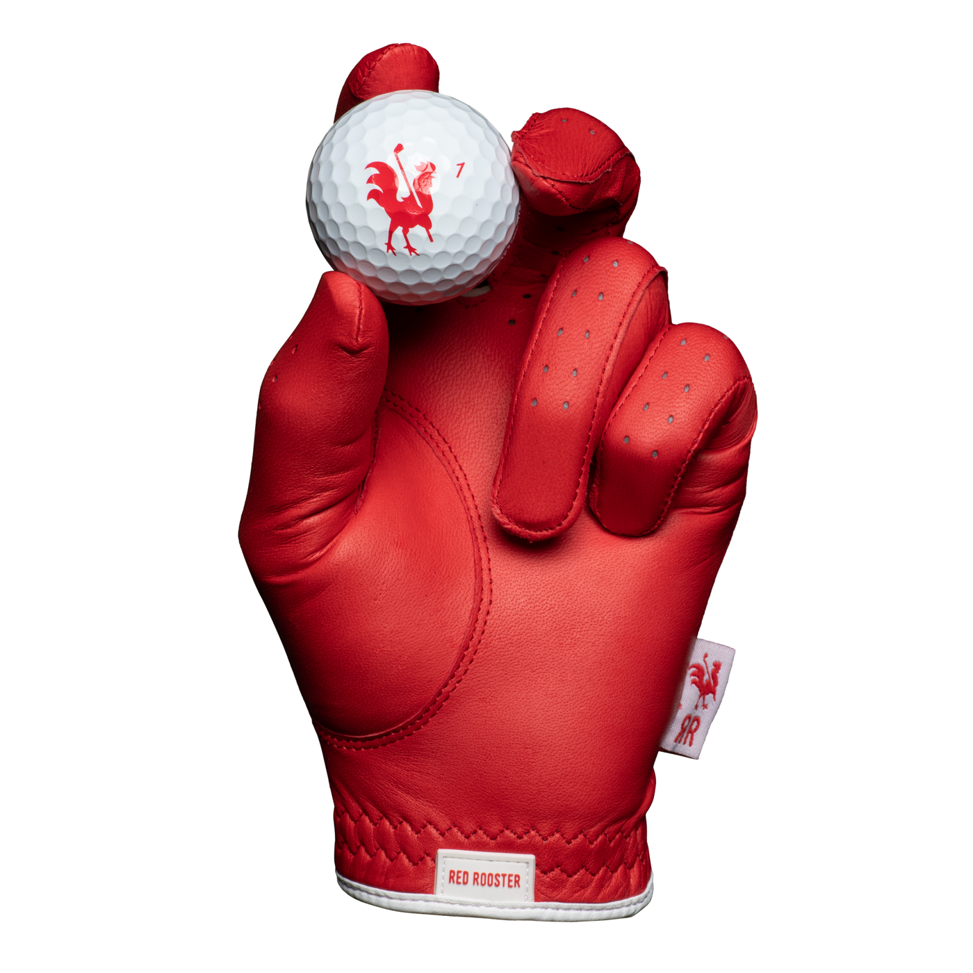 The Comb red golf glove holding golf ball