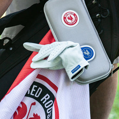 Women's Benny golf glove hanging with bags