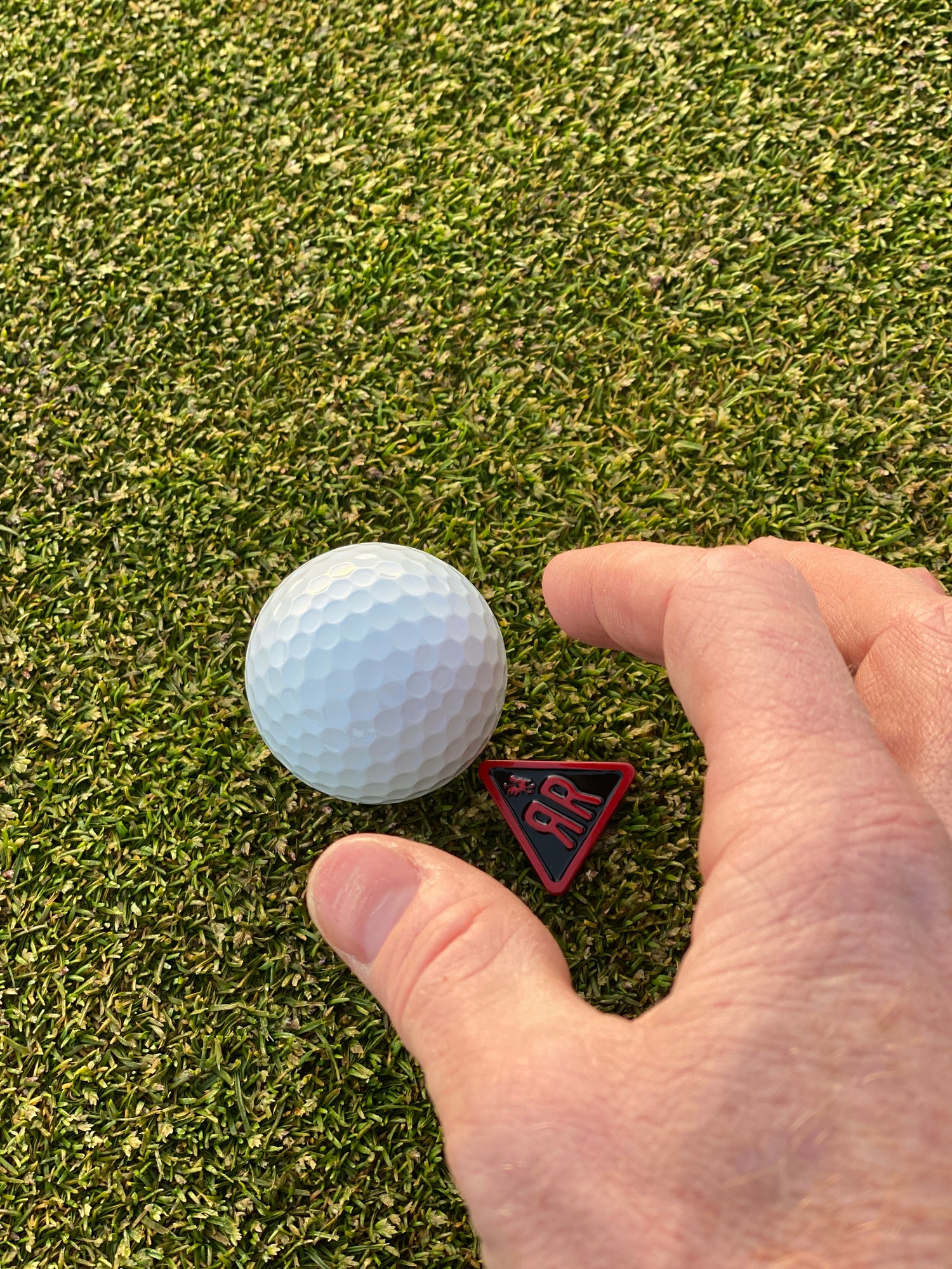 The Acute ball marker with golf ball