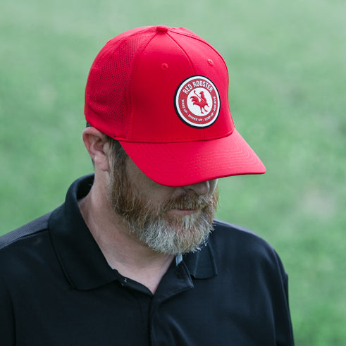 man wearing summit golf hat red