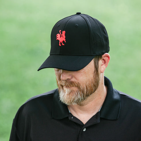 man wearing Apex black hat with red rooster logo