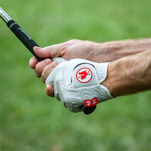 man wearing The Feather golf glove in left hand